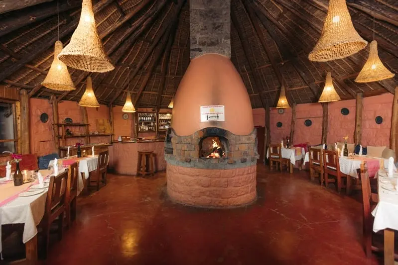 The wood-fired oven alight in the round dining room