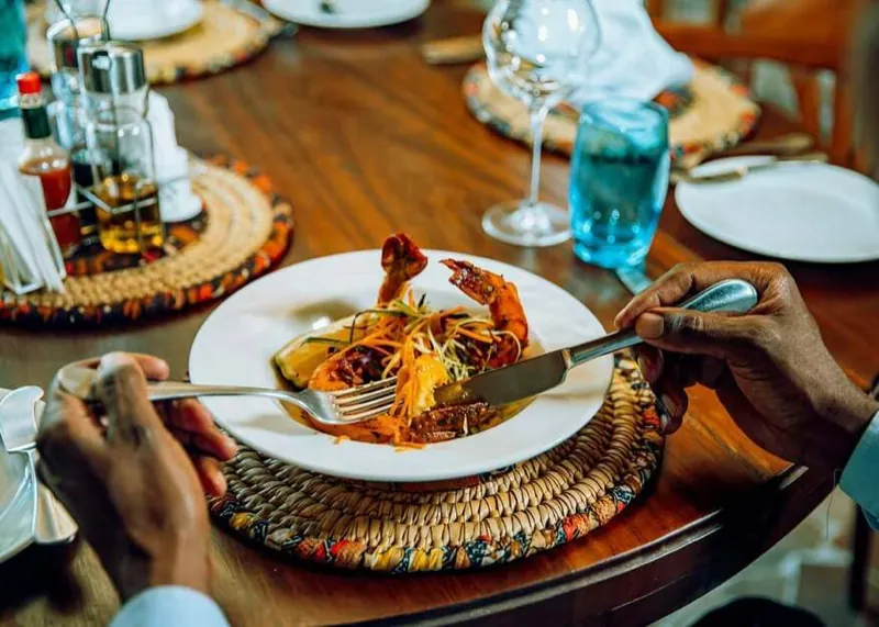 A plated dish of prawns and vegetables being served at the restaurant
